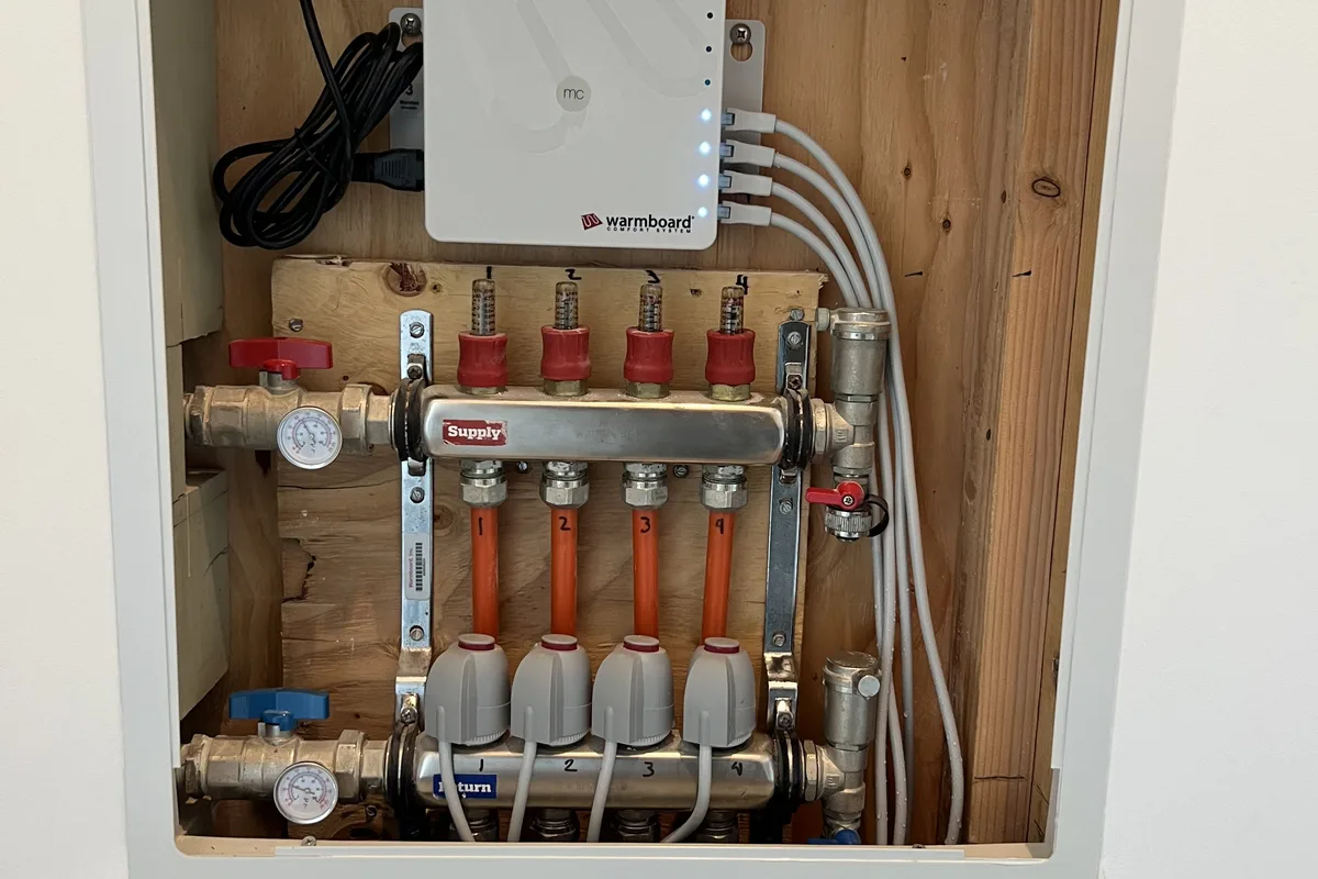 Recessed distribution manifold installed and labeled during a Central Coast remodel, ready for inspection before the wall closes.