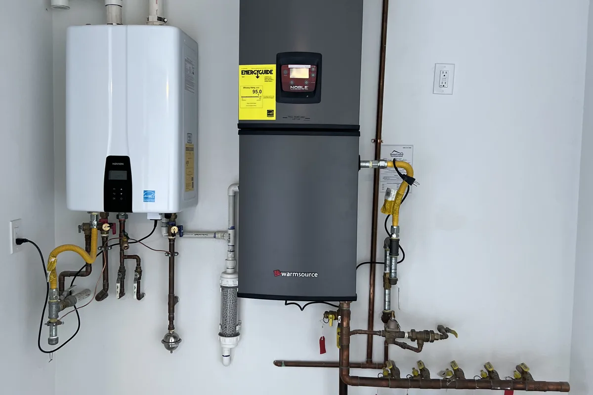 Heavy-duty water heater setup completed on a new construction project with code-required strapping and relief piping.