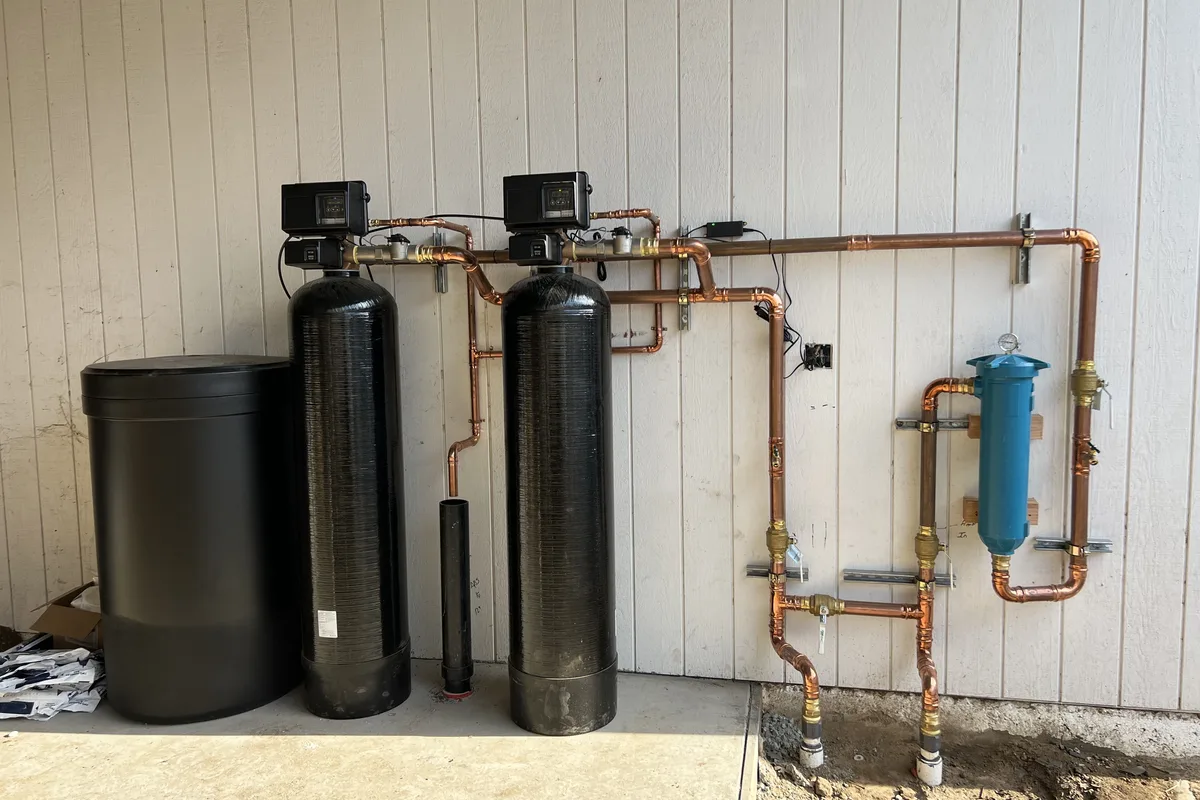 Multi-stage water treatment system installed in a Central Coast utility room by DAE Plumbing.